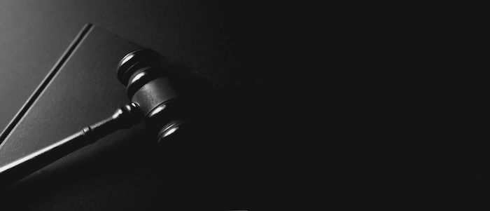 justice concept. gavel and law on table, black background